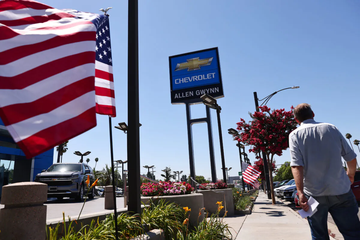 A person walks past a Chevrolet dealership in Glendale, Calif., on Aug. 4, 2021. (Mario Tama/Getty Images)