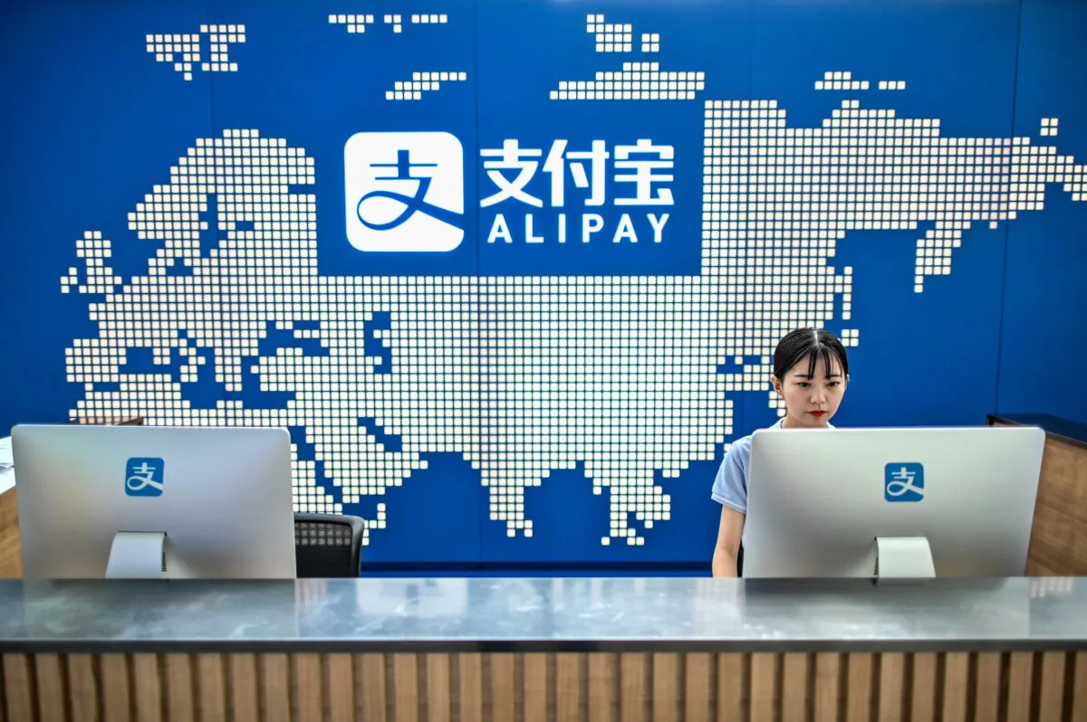 An employee works on a computer at the Alipay reception of the Shanghai office building of Ant Group in China on Aug. 28, 2020. (Hector Retamal/AFP via Getty Images)