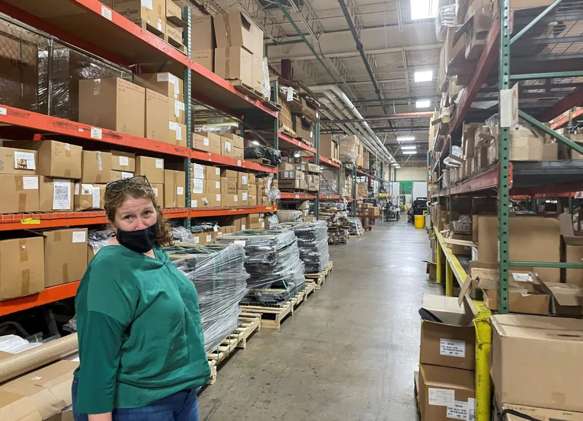 Diamond Brand COO Lauren Rash stands in an aisle of shelves with stockpiled parts as the 'lean' supply management has been upended by global shortages and bottlenecks, at Diamond Brand factory in Fletcher, outside Asheville, N.C., on Aug. 11, 2021. (Howard Schneider/Reuters)