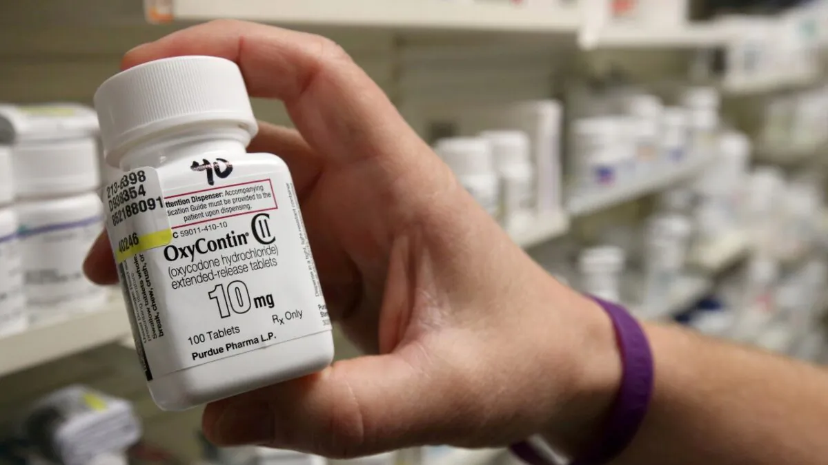 A pharmacist holds a bottle of OxyContin made by Purdue Pharma, at a pharmacy in Provo, Utah, on May 9, 2019. (George Frey/Reuters)