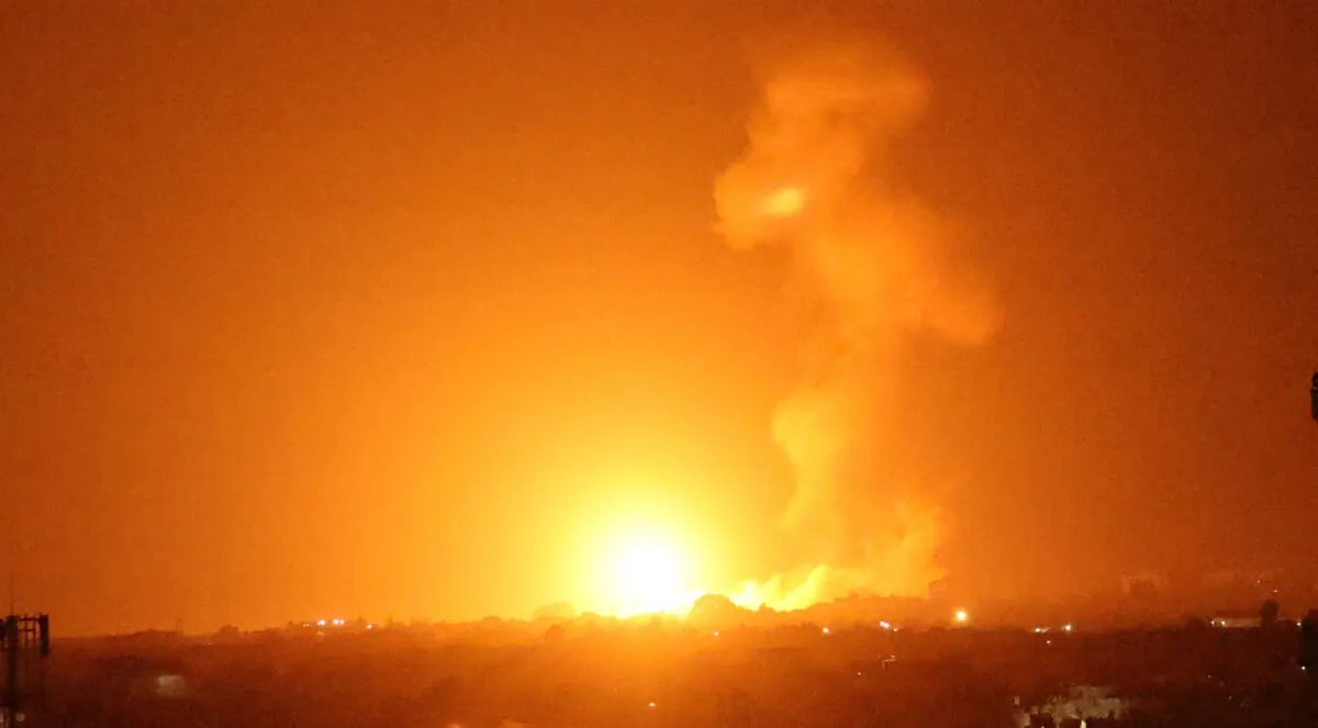 A fireball rises following an air strike in Khan Yunis in the southern Gaza Strip, late on Aug. 23, 2021. (Said Khatib/AFP via Getty Images)