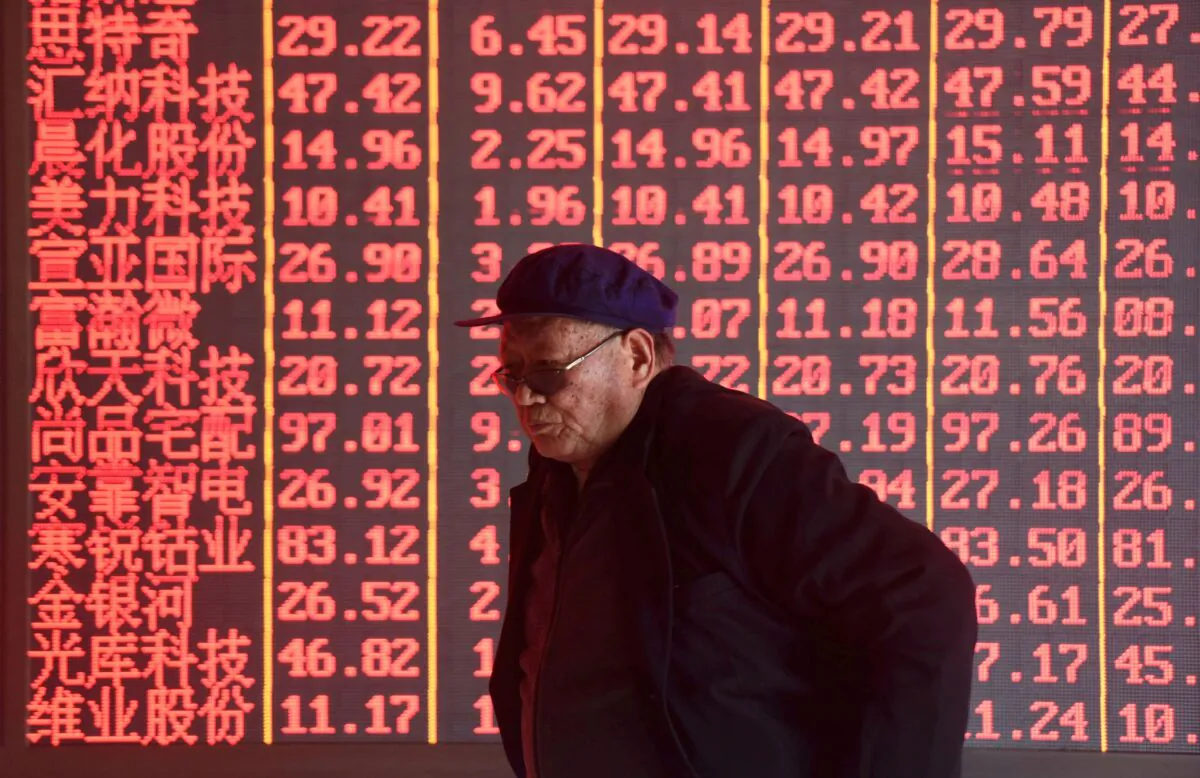  A man stands in front of an electronic board displaying stock information at a brokerage firm in Hangzhou, Zhejiang Province, China on April 1, 2019. (Stringer/Reuters)