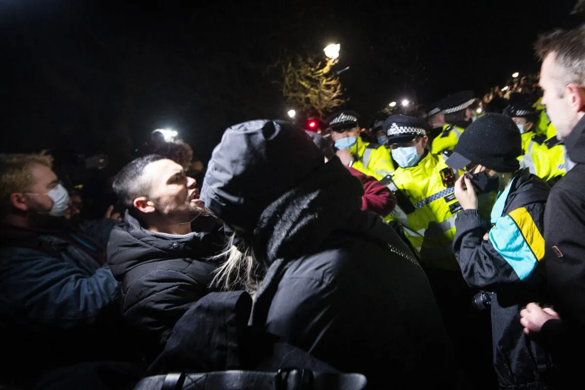 People clash with police as they gather in Clapham Common, London, after the Reclaim These Streets vigil for Sarah Everard was officially cancelled, on March 13, 2021. (Victoria Jones/PA)