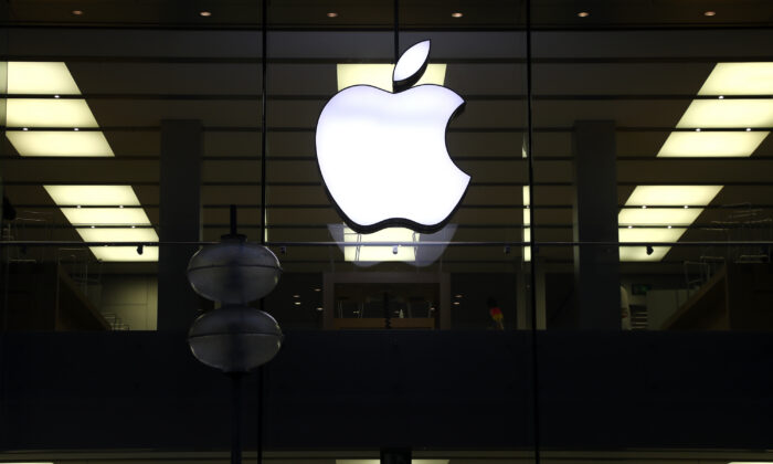 An illuminated Apple logo astatine  a store   successful  Munich, Germany, connected  Dec. 16, 2020. (Matthias Schrader/AP Photo)