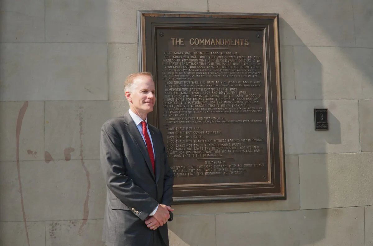 Former attorney Bill McSwain stands beside the Ten Commandments plaque at Chester County Courthouse in Pennsylvania, in an undated photograph. (Lily Sun/The Epoch Times)