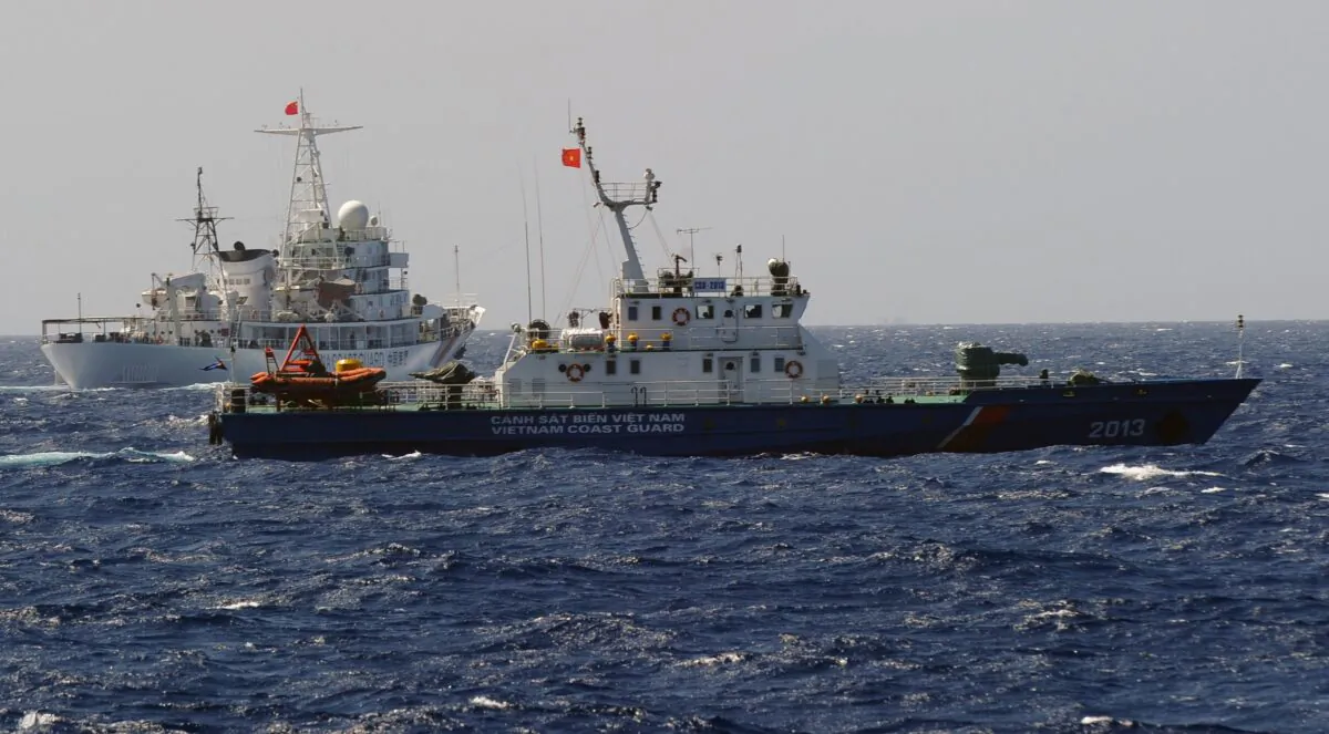 This picture taken from a Vietnam Coast Guard ship on May 14, 2014 shows a China Coast Guard ship (L) chasing a Vietnam Coast Guard vessel near the site of a Chinese oil drilling rig being installed at the disputed water in the South China Sea off Vietnam's central coast. The Vietnam National Assembly's deputies, gathered for their summer session, are discussing the escalating tensions with China over the South China Sea's contested waters.      (HOANG DINH NAM/AFP via Getty Images)