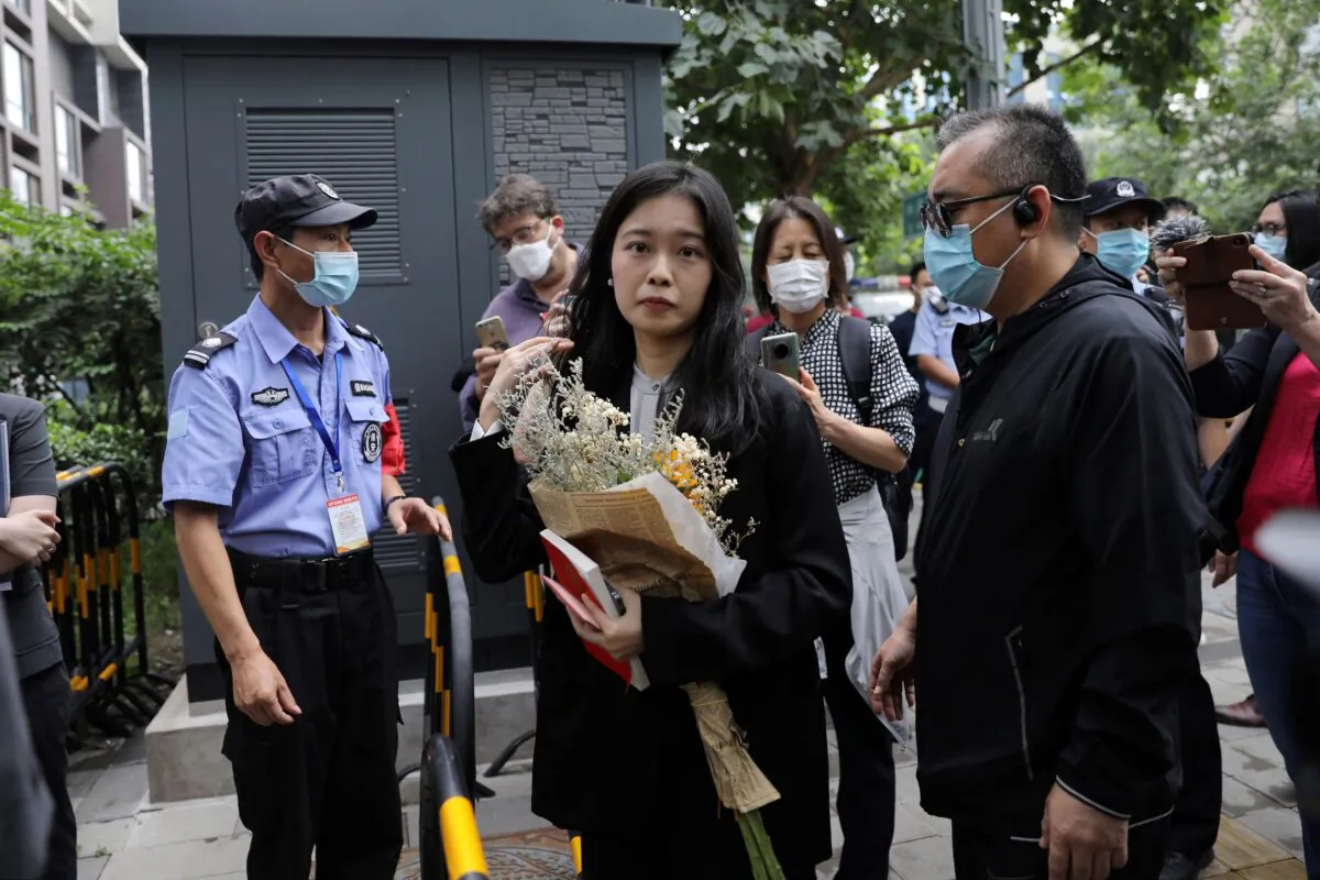 Zhou Xiaoxuan, also known by her online name Xianzi, arrives at a court for a sexual harassment case involving a Chinese state TV host, in Beijing, China, on Sept. 14, 2021. (Tingshu Wang/Reuters)