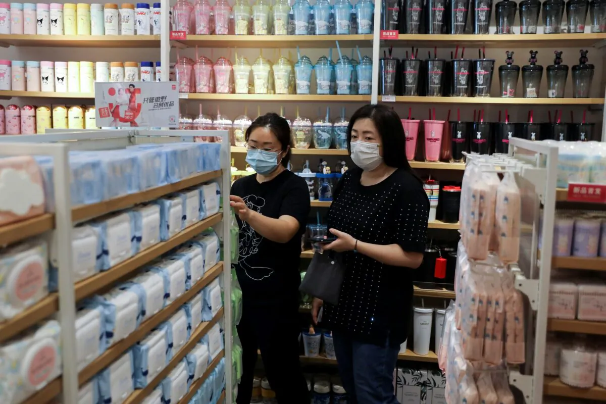 Customers shop at a store of Chinese retailer MINISO Group in Beijing, China on Sept. 13, 2021. (Tingshu Wang/Reuters)