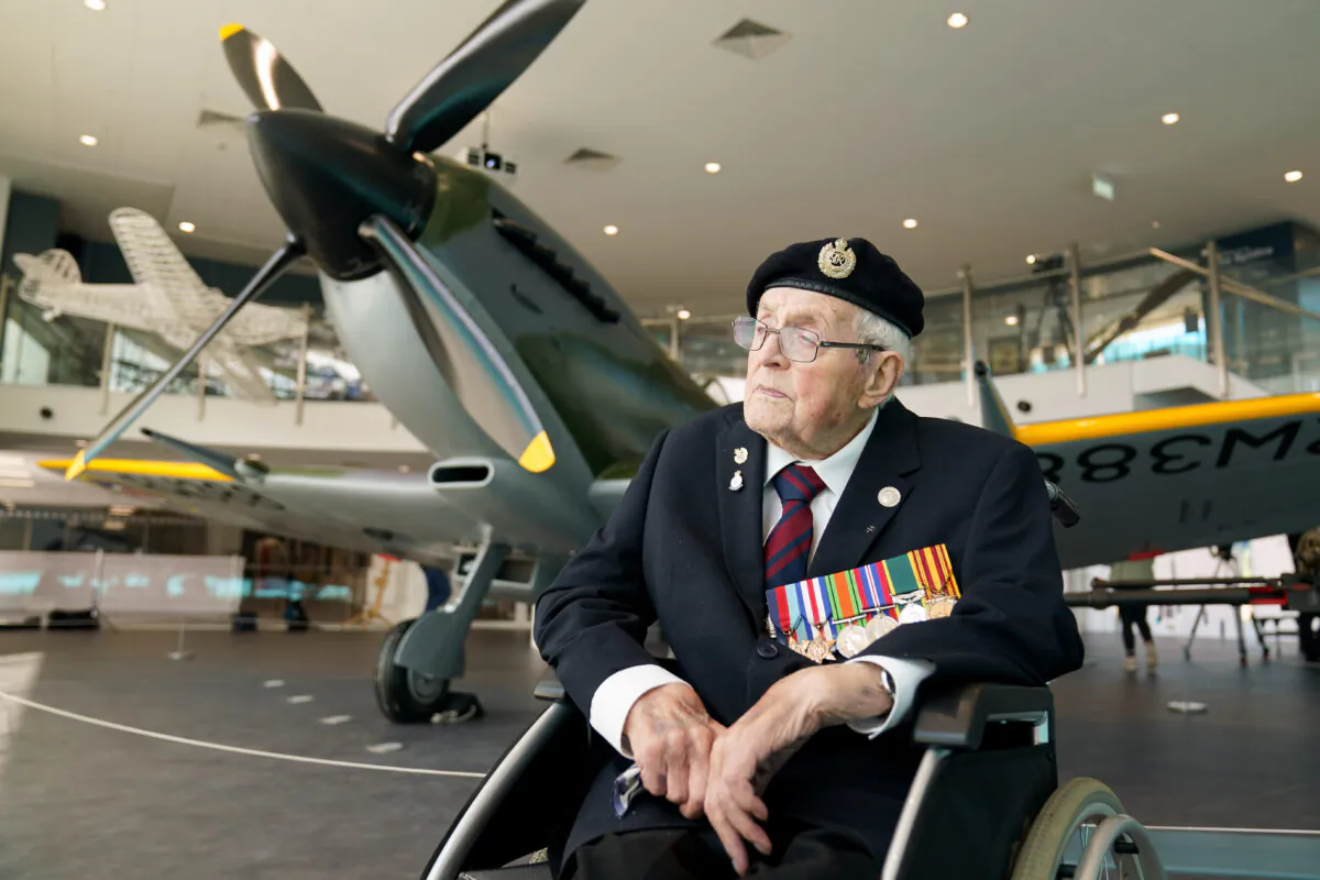Veteran Norman Lewis, 102, beside the newly restored Spitfire at the Potteries Museum And Art Gallery in Stoke-on-Trent, Staffordshire, UK, on Sept. 13, 2021.  (Jacob King/PA)