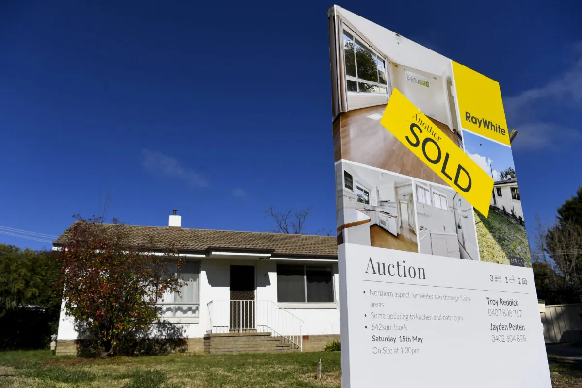 A ‘SOLD’ sticker is seen on a sale sign in front of a house in Canberra, Australia, May 18, 2021. (Lukas Coch/AAP Image)