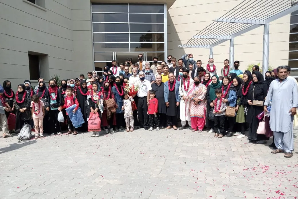 Members of the Afghan women's soccer team along with their families pose for a group photo upon their arrival at the Pakistan Footbal Federation in Lahore, Pakistan, on Sept. 15, 2021. (Punjab Sports Department/Handout via Reuters)