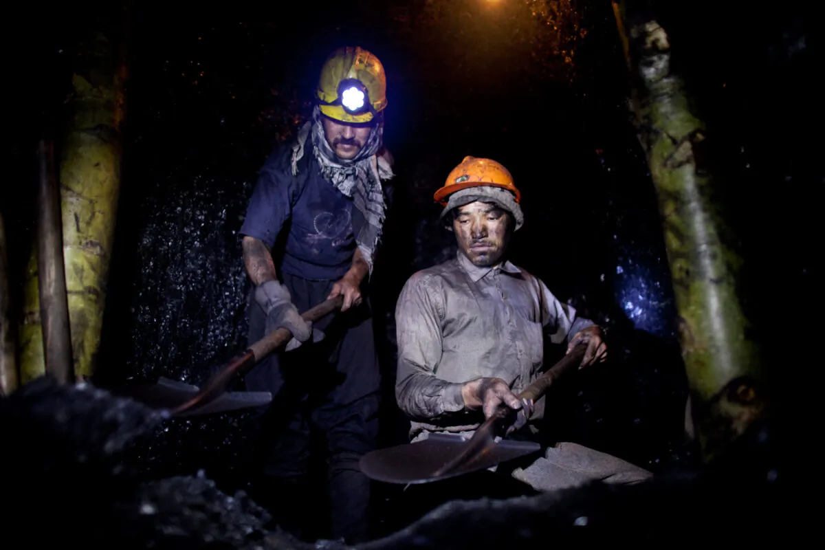 Afghan miners work in a coal mine 100 km east of the western city of Herat in Afghanistan, on June 26, 2010. (Majid Saeedi/Getty Images)