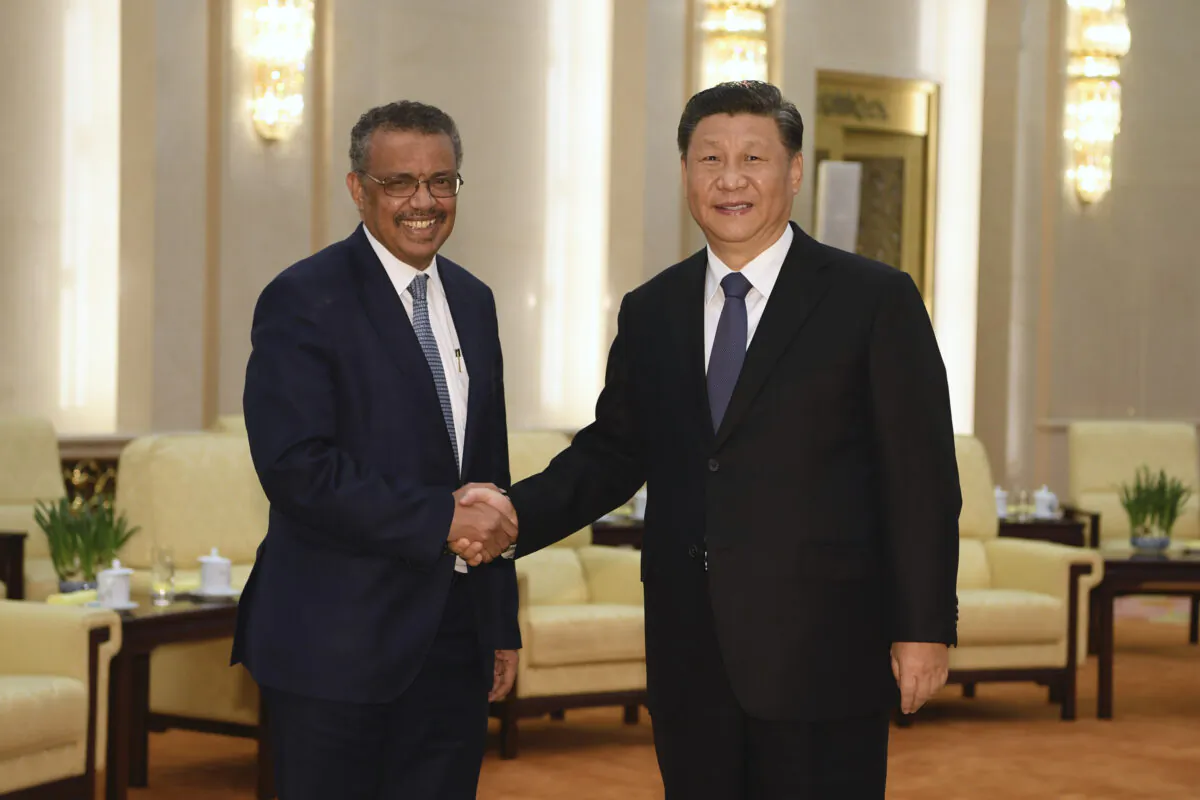 WHO Director General Tedros Adhanom (L) shakes hands with Chinese Communist Party leader Xi Jinping before a meeting in Beijing on Jan. 28, 2020. (Naohiko Hatta/Pool/Getty Images)