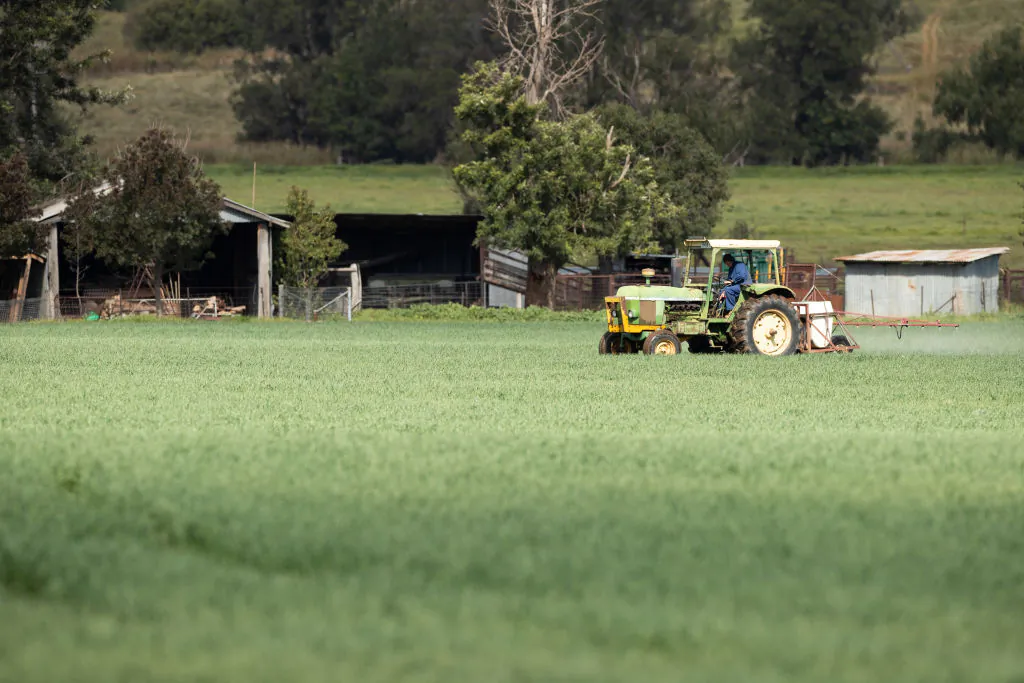 A farmer on a tractor sprays his crop in north west New South Wales, Australia, on May 5, 2020. (Mark Kolbe/Getty Images)
