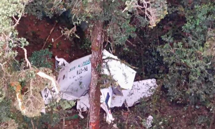 On September 15, 2021, a rescue helicopter in a mountain near Intanjaya, Papua, Indonesia, reveals the remains of a small Limbun Air freighter.  (Basarnas via AP)