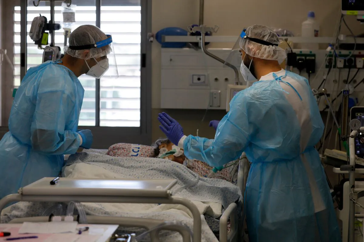 Israeli medical personnel tend to COVID-19 patients inside an isolation ward at the Ziv Medical Centre in the city of Safed in northern Israel on Aug. 12, 2021. (Jalaa Marey/AFP via Getty Images)
