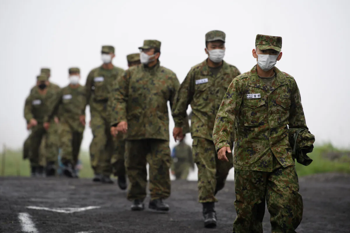 Japan's Ground Self-Defense Forces (JGSDF) soldiers arrive for a live-fire exercise at JGSDF's training grounds in the East Fuji Maneuver Area on May 22, 2021 in Gotemba, Shizuoka, Japan. (Akio Kon - Pool/Getty Images)