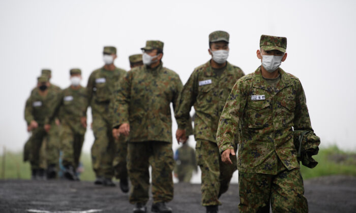 Japan's Ground Self-Defense Forces (JGSDF) soldiers arrive for a live-fire exercise at JGSDF's training grounds in the East Fuji Maneuver Area on May 22, 2021 in Gotemba, Shizuoka, Japan. (Akio Kon - Pool/Getty Images)