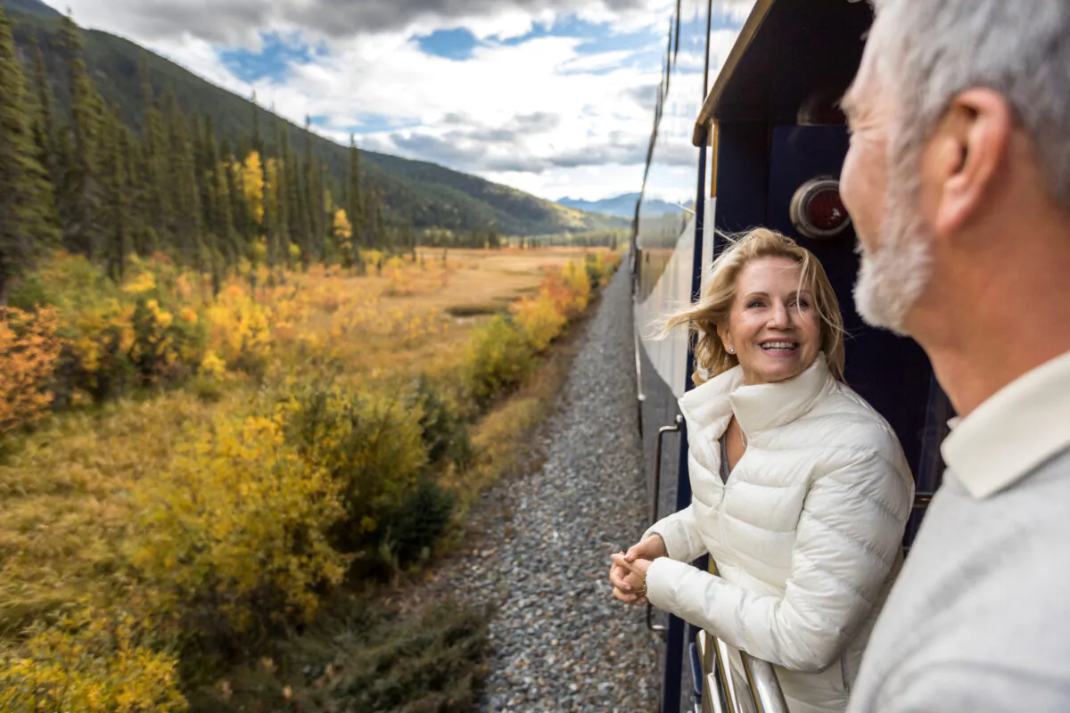 A couple enjoys the view from the GoldLeaf service outdoor viewing platform. (Rocky Mountaineer)