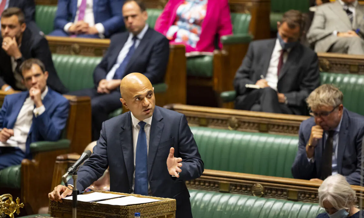 British Health Secretary Sajid Javid speaks in the House of Commons with mostly unmasked Tory MPs sitting behind him in Westminster, London, on Sept. 14, 2021. (UK Parliament/Roger Harris/PA)