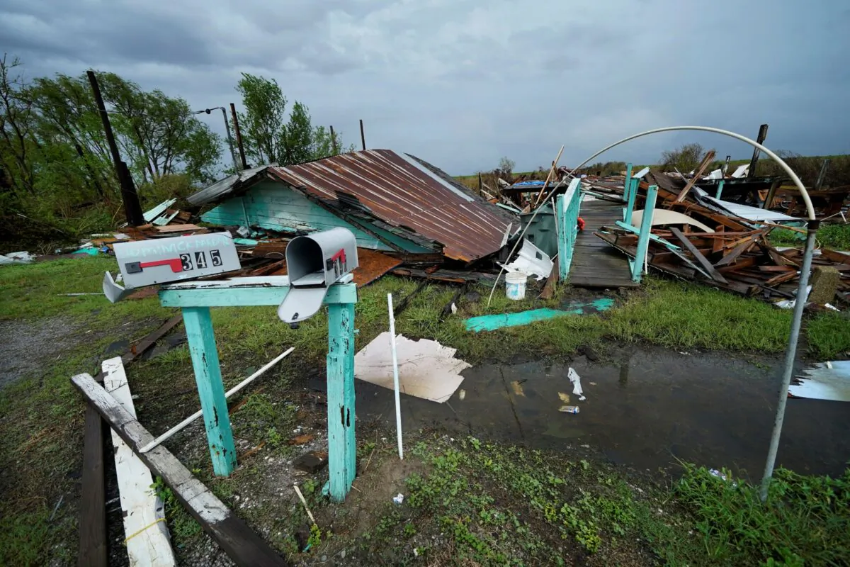 Storm clouds from Tropical Storm Nicholas are seen behind homes of the vanishing Native American community of Isle de Jean Charles, La., on Sept. 14, 2021. (Gerald Herbert/AP Photo)