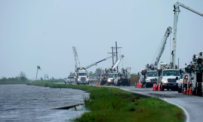 Utility crews replace power poles destroyed by Hurricane Ida as Tropical Storm Nicholas approaches in Pointe-aux-Chenes, La., on Sept. 14, 2021. (Gerald Herbert/AP Photo)