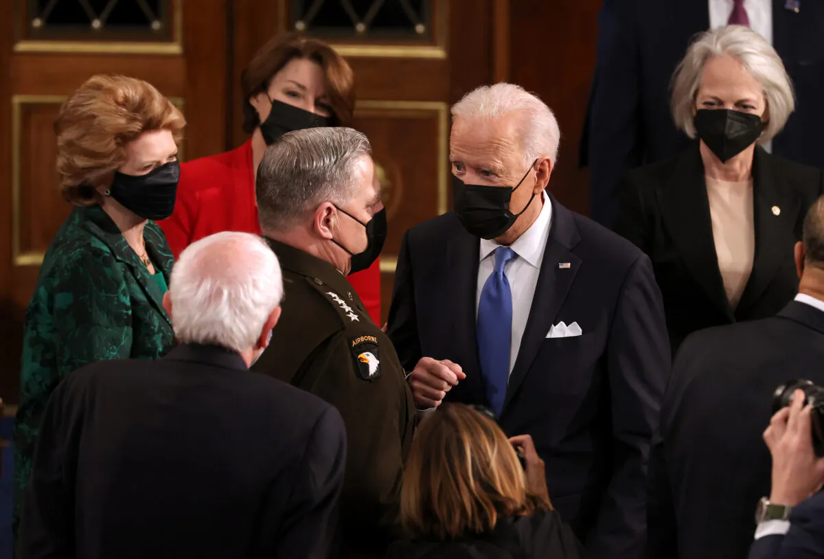President Joe Biden speaks with Chairman of the Joint Chiefs of Staff Mark A. Milley (L) after addressing a joint session of Congress at the U.S. Capitol in Washington on April 28, 2021. (Chip Somodevilla/Getty Images)