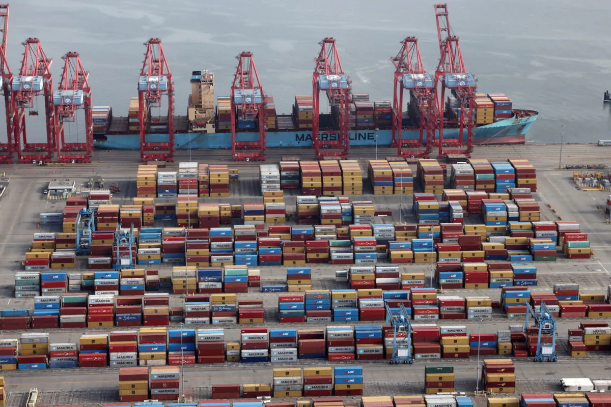 Shipping containers are unloaded from a ship at a container terminal at the Port of Long Beach-Port of Los Angeles complex on April 7, 2021. (Lucy Nicholson/File Photo/Reuters)