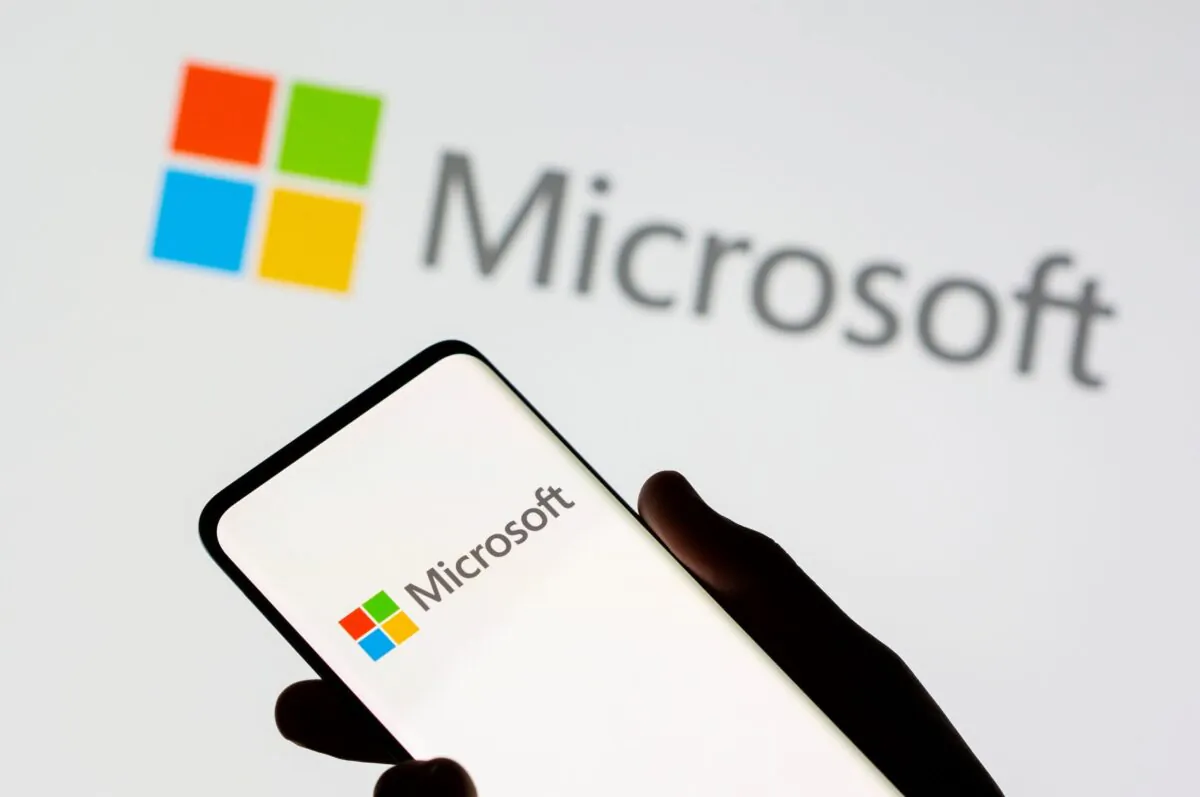 A smartphone is seen in front of a Microsoft logo displayed in this illustration taken on July 26, 2021. (Dado Ruvic/Illustration/Reuters)