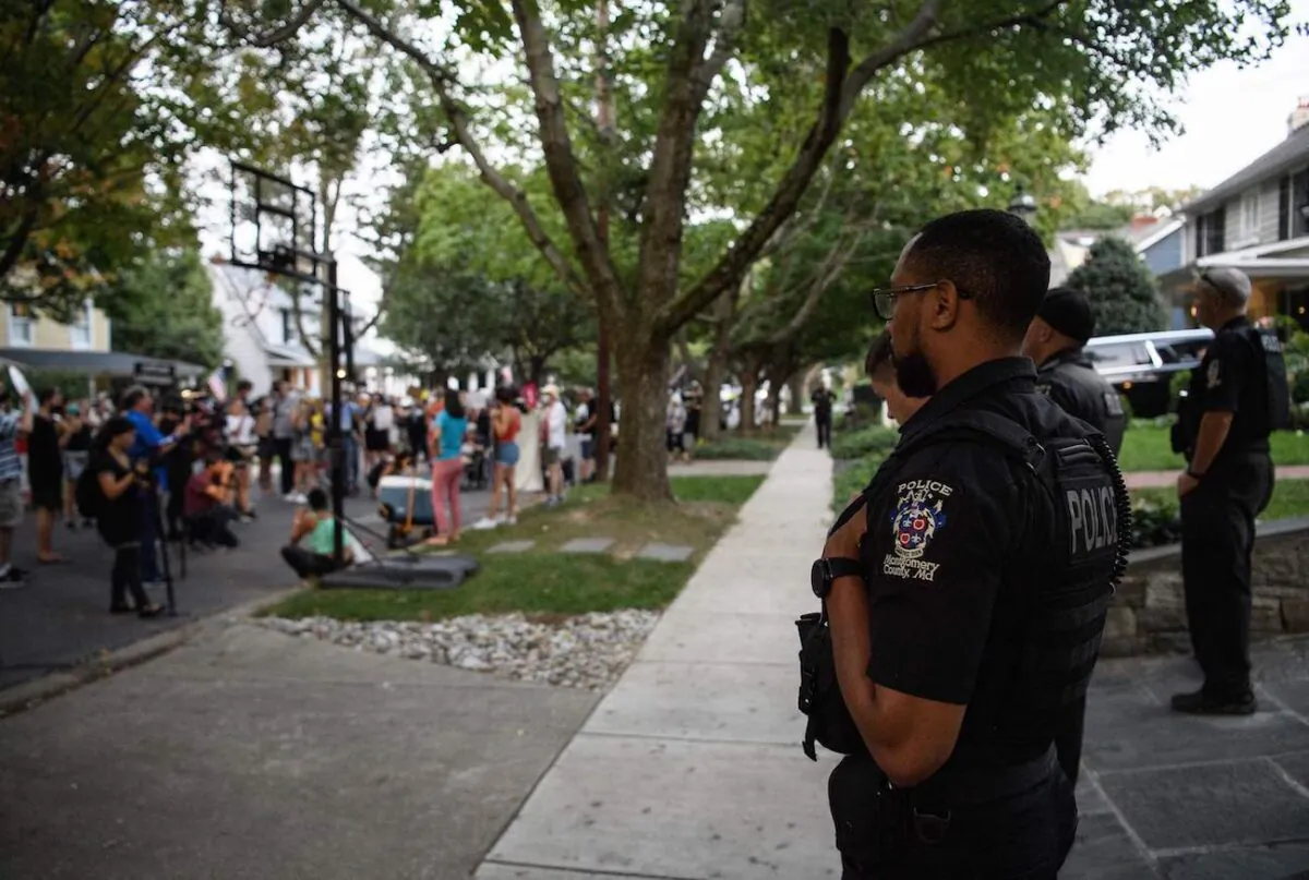 Police stand guard as activists protest near the house of U.S. Supreme Court Justice Brett Kavanaugh in a file photo. (Nicholas Kamm/AFP via Getty Images)