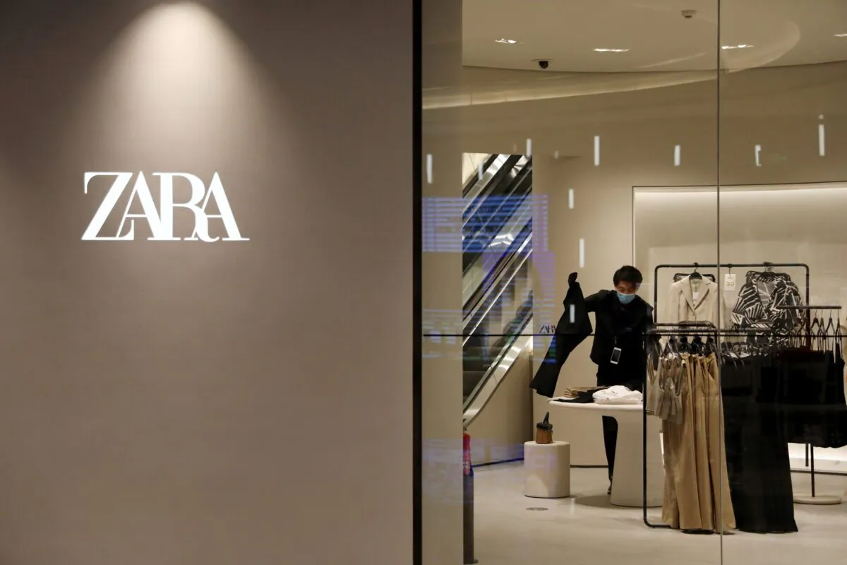 A staff member sorts clothes inside a clothing store of Inditex's Zara brand at a newly opened shopping mall in Beijing, China on April 16, 2021. (Tingshu Wang/Reuters)