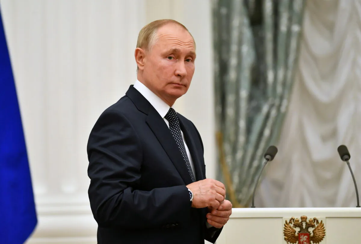 Russian President Vladimir Putin looks on during a meeting with athletes, participants of the 2020 Tokyo Olympic Games, in Moscow on Sept. 11, 2021. (Sputnik/Evgeny Biyatov/Kremlin via Reuters)