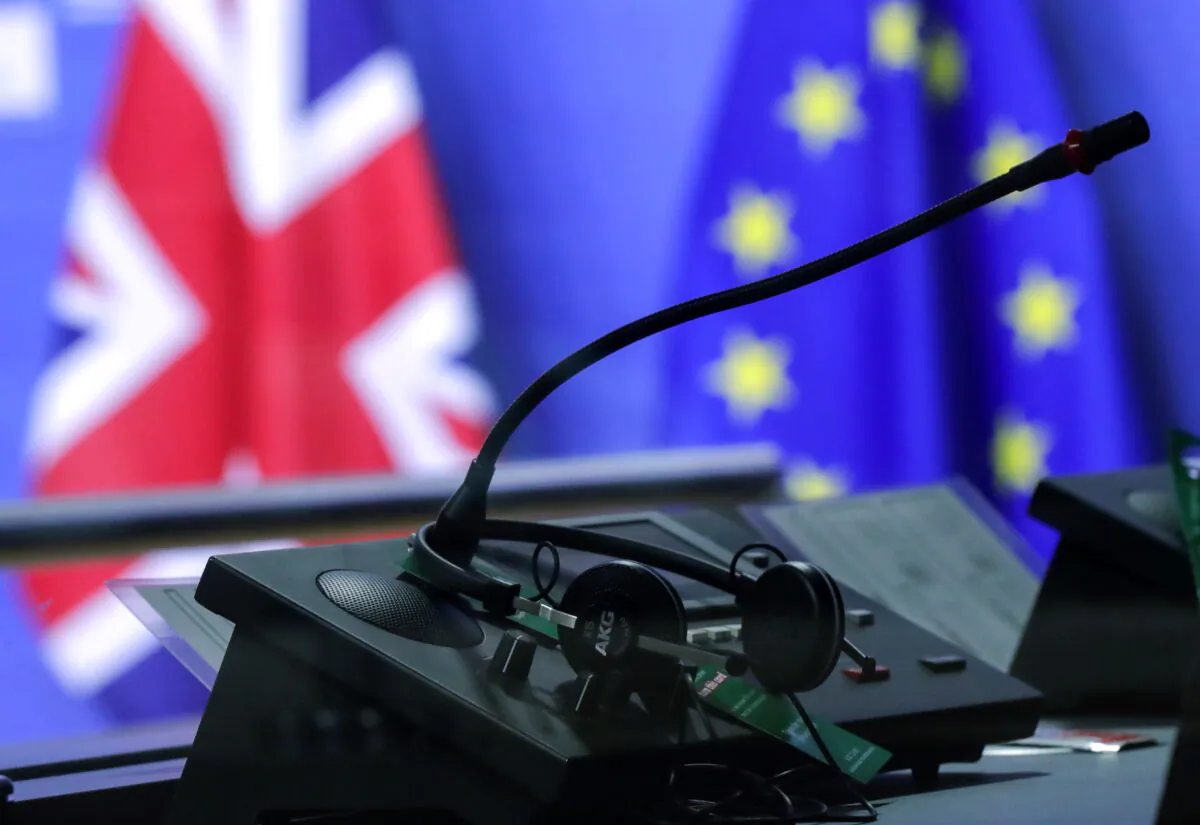 Flags of the Union Jack and European Union are seen through an interpreter's booth ahead of the meeting of European Commission President Ursula von der Leyen and British Prime Minister Boris Johnson, in Brussels on Dec. 9, 2020. (Olivier Hoslet/Pool via Reuters)