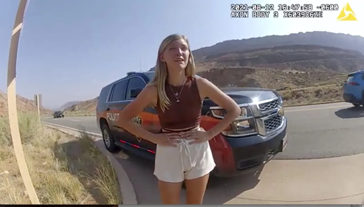 Gabrielle “Gabby” Petito talks to a police officer after police pulled over the van she was traveling in with her boyfriend, Brian Laundrie, near the entrance to Arches National Park in Utah on Aug. 12, 2021, in a still image taken from police body camera video. (The Moab Police Department via AP)