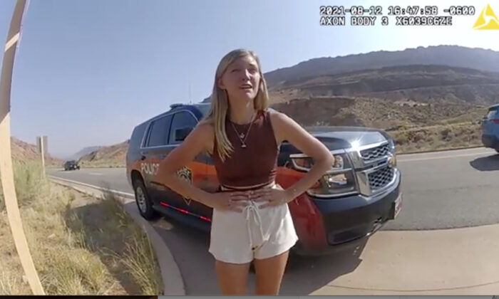 Gabrielle “Gabby” Petito talks to a police officer after police pulled over the van she was traveling in with her boyfriend, Brian Laundrie, near the entrance to Arches National Park in Utah on Aug. 12, 2021, in a still image taken from police body camera video. (The Moab Police Department via AP)