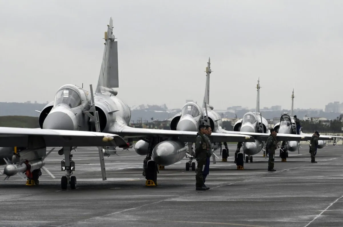 Taiwan air force pilots stand next to French-made Mirage fighter jets during an annual exercise at the Hsinchu air force base on Jan. 16, 2019. (Sam Yeh/AFP via Getty Images)