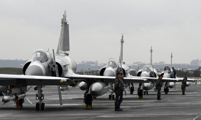 Taiwan air force pilots stand next to French-made Mirage fighter jets during an annual exercise at the Hsinchu air force base on Jan. 16, 2019. (Sam Yeh / AFP via Getty Images)