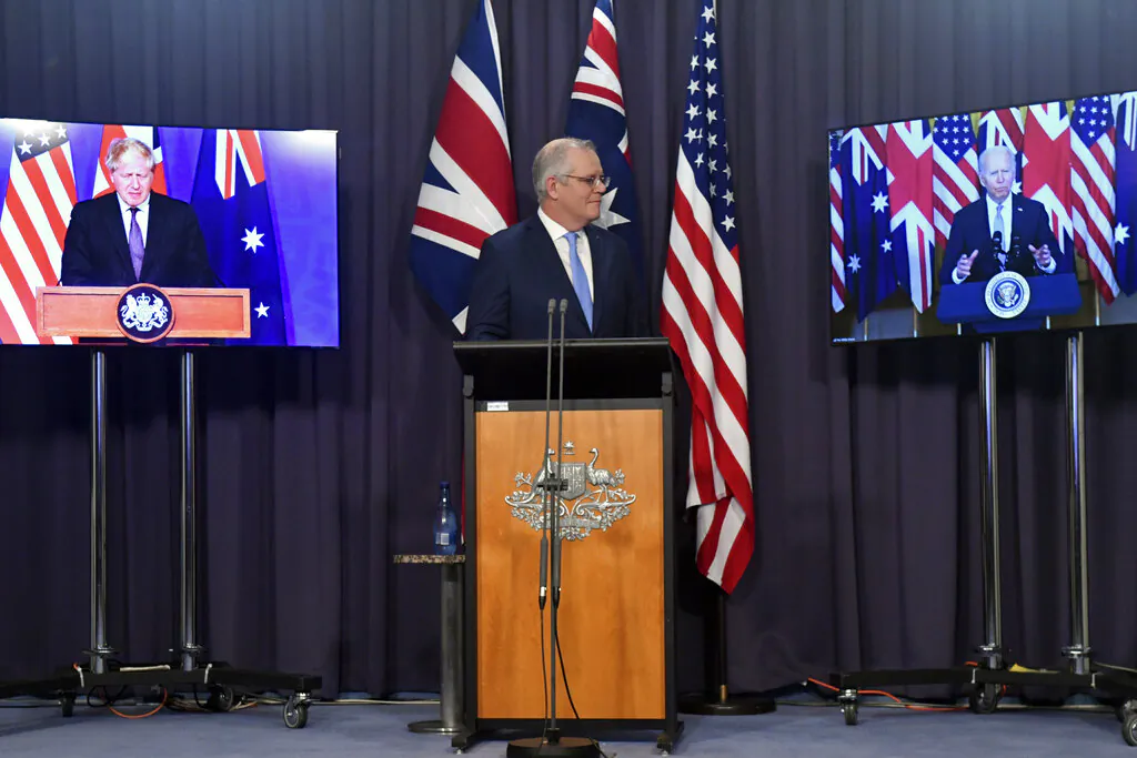 Australia's Prime Minister Scott Morrison (C) appears on stage with video links to Britain's Prime Minister Boris Johnson (L) and U.S. President Joe Biden at a joint press conference at Parliament House in Canberra, Australia, on Sept. 16, 2021. (Mick Tsikas/AAP Image via AP)