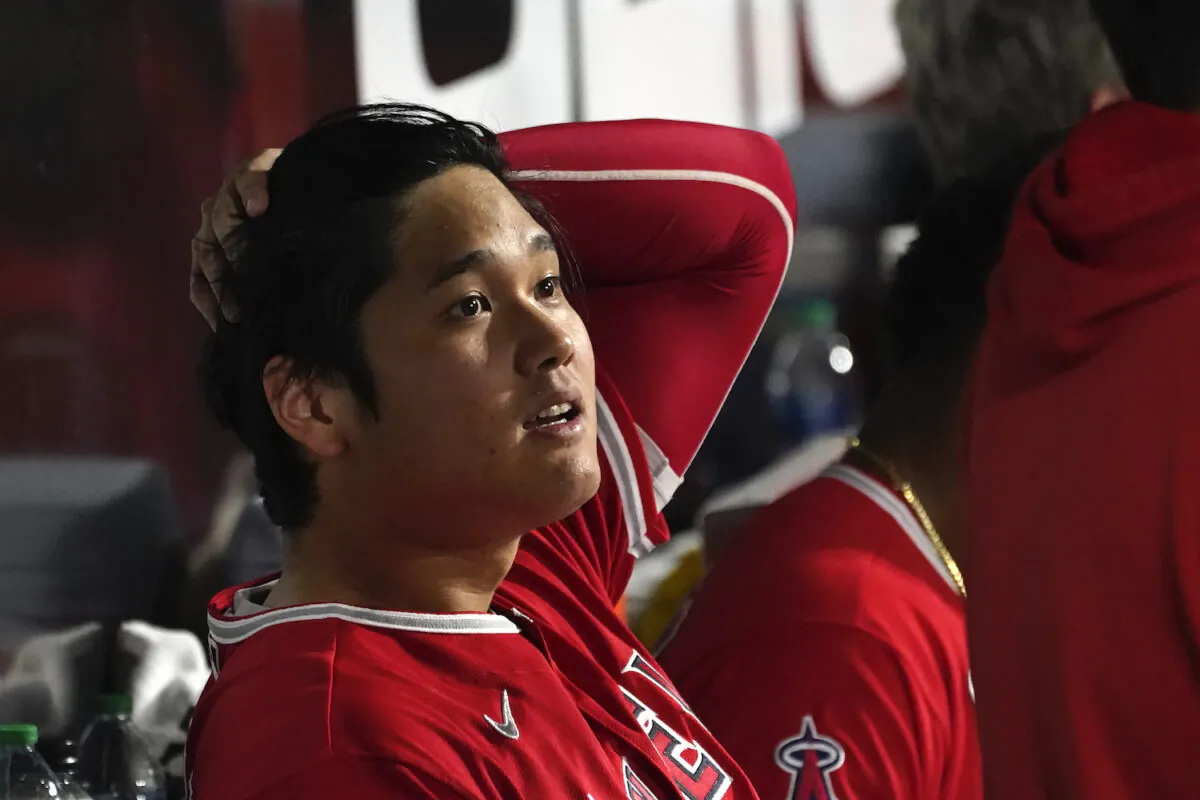 Los Angeles Angels' Shohei Ohtani sits in the dugout after being called out on strikes during the fourth inning of the team's baseball game against the Chicago White Sox in Chicago on Sept. 14, 2021. (AP Photo/Charles Rex Arbogast)