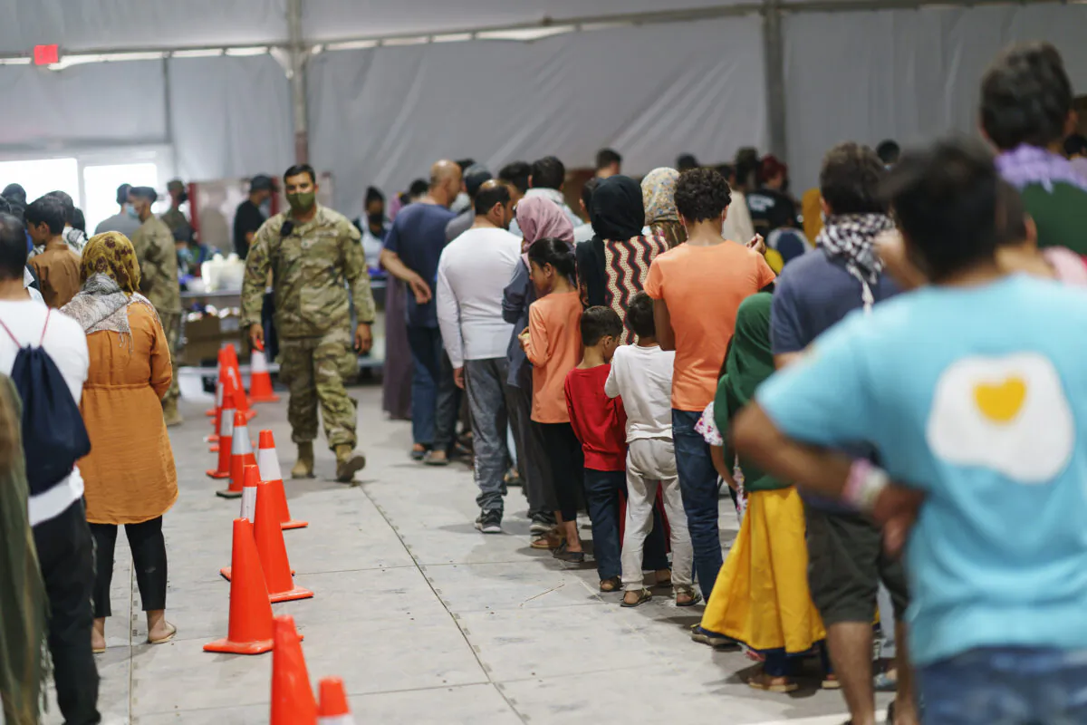 Afghan refugees line up for food in a dining hall at Fort Bliss' Doña Ana Village, N.M., on Sept. 10, 2021. (David Goldman/AP Photo)