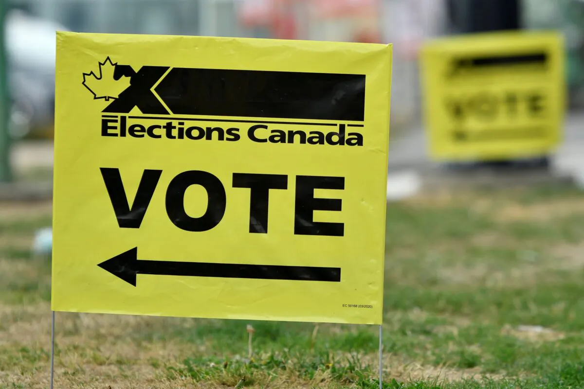 Signs outside an advance polling station in Burnaby, B.C., on Sept. 10, 2021. (Jennifer Gauthier/Reuters)