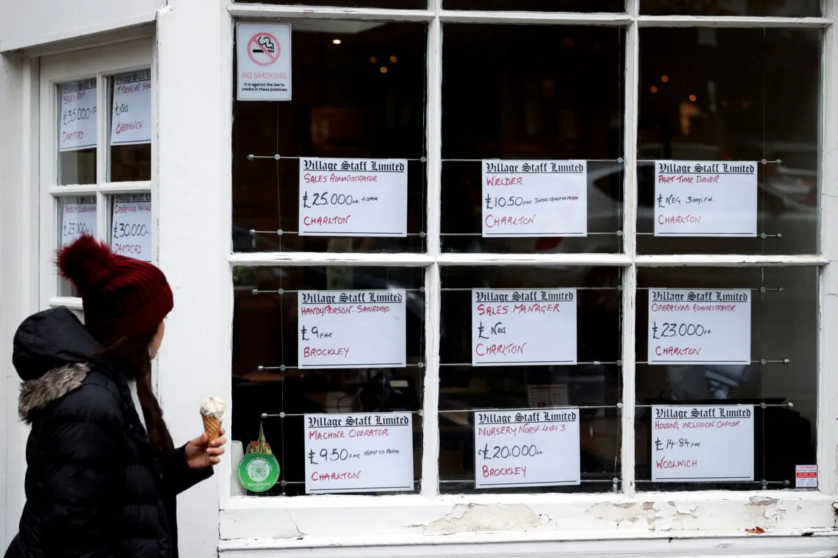 A person looks at the adverts in the window of a job agency in London, Britain on Oct. 13, 2020. (Hannah McKay/Reuters)