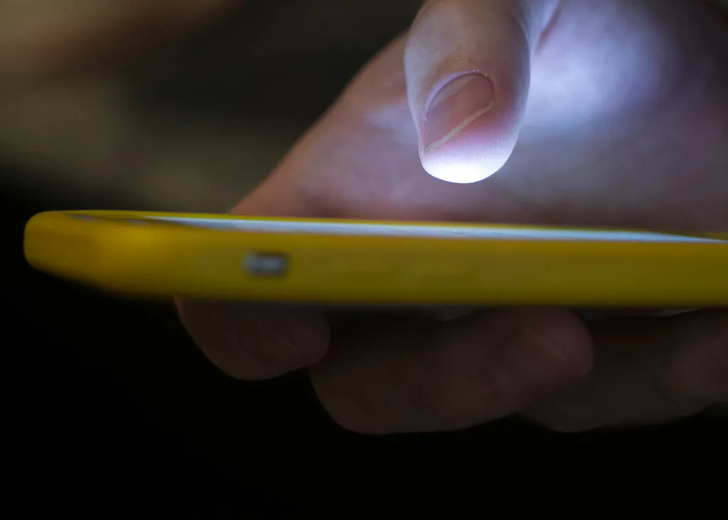 A man uses a cellphone in New Orleans, on Aug. 11, 2019. (Jenny Kane/AP Photo)
