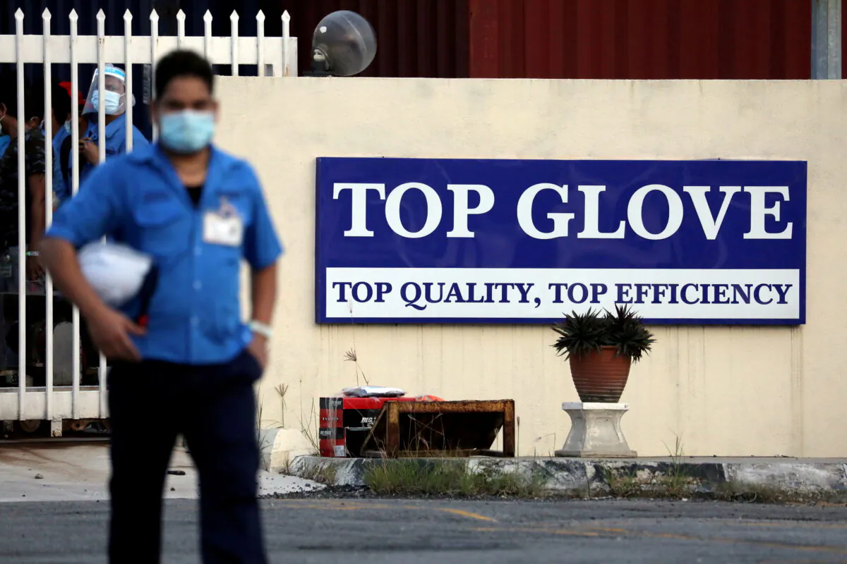 A worker leaves a Top Glove factory after his shift in Klang, Malaysia on Dec. 7, 2020. (Lim Huey Teng/Reuters)