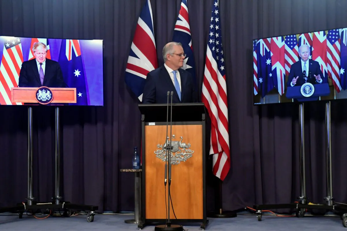 Australia's Prime Minister Scott Morrison appears on stage with video links to Britain's Prime Minister Boris Johnson (L) and U.S. President Joe Biden at a joint press conference at Parliament House in Canberra on Sept. 16, 2021. (Mick Tsikas/AAP Image via AP)