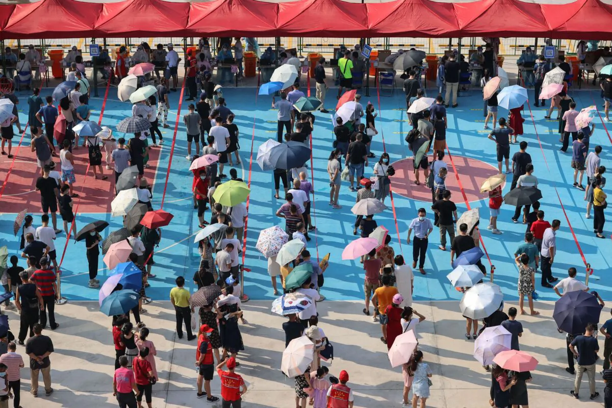 Residents queue to undergo nucleic acid tests for the COVID-19 coronavirus in Xiamen city, in China's eastern Fujian Province, on Sept. 14, 2021. (STR/AFP)