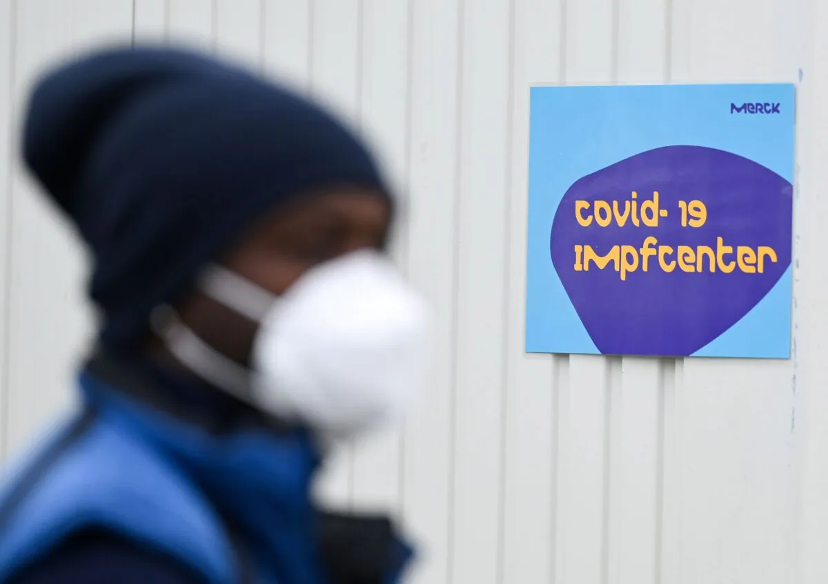 An employee of the drugs and chemicals group Merck KGaA waits in line in front of a vaccination centre at Merck's plant in Darmstadt, Germany on May 4, 2021. (Arne Dedert/Pool via Reuters)