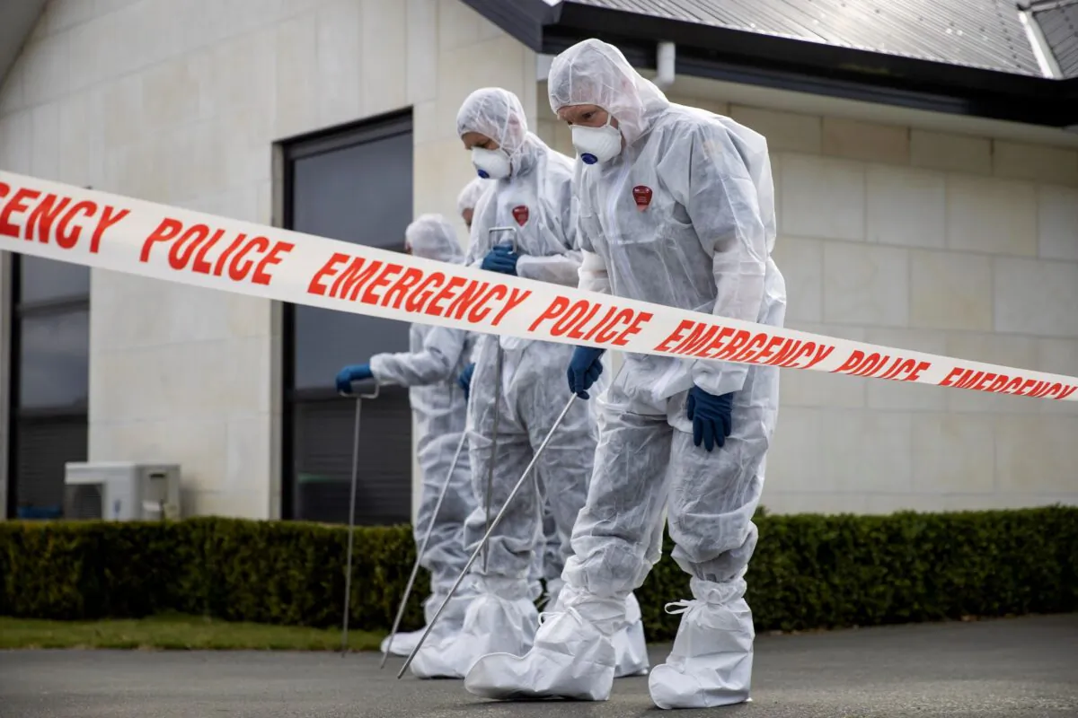 Police search the driveway of a house where three children were found dead in the South Island town of Timaru in New Zealand on Sept. 17, 2021.  (George Heard/New Zealand Herald via AP)