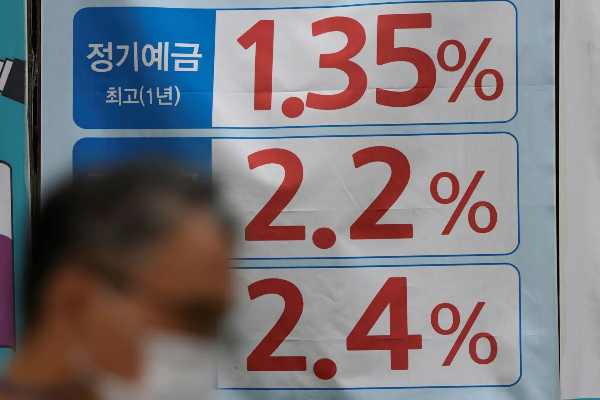 A man walks near an advertisement showing bank's interest rates in downtown Seoul, South Korea on Sept. 17, 2021. (Lee Jin-man/AP Photo)