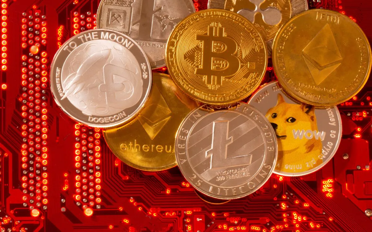 Representations of cryptocurrencies Bitcoin, Ethereum, Dogecoin, Ripple, Litecoin are placed on PC motherboard in this illustration taken on June 29, 2021. (Dado Ruvic/Illustration/Reuters)